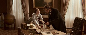 Movie still from “Abraham Lincoln: Vampire Hunter” (2012), directed by Timur Bekmambetov – A man and a woman are cutting a piece of paper; Medium shot, High angle