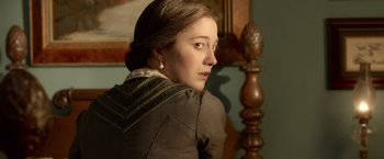 Movie still from “Abraham Lincoln: Vampire Hunter” (2012), directed by Timur Bekmambetov – A young woman in a brown jacket looking to her left; Close Up shot, Over the shoulder angle