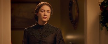 Movie still from “Abraham Lincoln: Vampire Hunter” (2012), directed by Timur Bekmambetov – A young woman in a black dress looking at the camera; Close Up shot, Over the shoulder angle