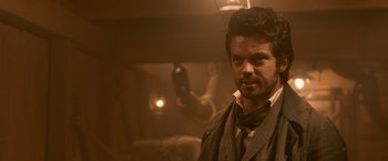 Movie still from “Abraham Lincoln: Vampire Hunter” (2012), directed by Timur Bekmambetov – A man with a beard standing in a dimly - lit room; Close Up shot, Over the shoulder angle