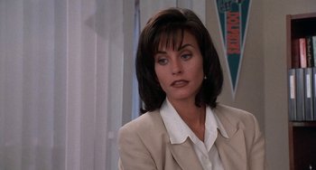 Movie still from “Ace Ventura: Pet Detective” (1994), directed by Tom Shadyac – A person wearing a suit and tie; Close Up shot, Over the shoulder angle