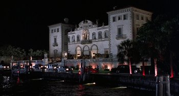 Movie still from “Ace Ventura: Pet Detective” (1994), directed by Tom Shadyac – A large building with lights on the front of it; Extreme Wide shot, Low angle