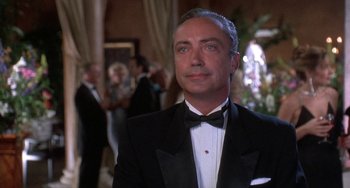 Movie still from “Ace Ventura: Pet Detective” (1994), directed by Tom Shadyac – A person wearing a suit and a bow tie; Close Up shot, Low angle