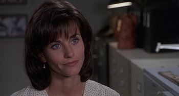 Movie still from “Ace Ventura: Pet Detective” (1994), directed by Tom Shadyac – A person wearing a white shirt; Close Up shot, Over the shoulder angle