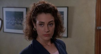 Movie still from “Ace Ventura: Pet Detective” (1994), directed by Tom Shadyac – A person wearing a jacket; Close Up shot, Over the shoulder angle