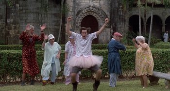 Movie still from “Ace Ventura: Pet Detective” (1994), directed by Tom Shadyac – A group of people dressed up in costumes; Wide shot, Low angle