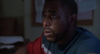 Movie still from “Ace Ventura: Pet Detective” (1994), directed by Tom Shadyac – A person looking at the camera; Close Up shot, Low angle