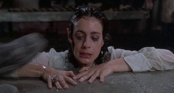 Movie still from “Ace Ventura: Pet Detective” (1994), directed by Tom Shadyac – A woman with wet hair and a ring on her finger; Close Up shot, High angle