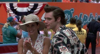 Movie still from “Ace Ventura: Pet Detective” (1994), directed by Tom Shadyac – A man and a woman standing next to each other; Close Up shot, Over the shoulder angle