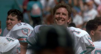 Movie still from “Ace Ventura: Pet Detective” (1994), directed by Tom Shadyac – A man smiling while wearing a football uniform; Close Up shot, Low angle