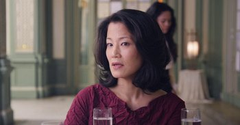 A person sitting at a table with a glass of water