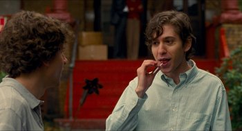 Movie still from “Adventureland” (2009), directed by Greg Mottola – A young man brushing his teeth while standing next to another young man; Close Up shot, Over the shoulder angle