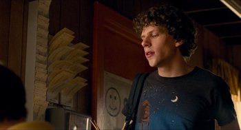 Movie still from “Adventureland” (2009), directed by Greg Mottola – A man with curly hair is looking upward; Medium shot, Over the shoulder angle