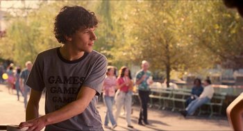 Movie still from “Adventureland” (2009), directed by Greg Mottola – A group of young people standing on a sidewalk; Medium shot, Over the shoulder angle