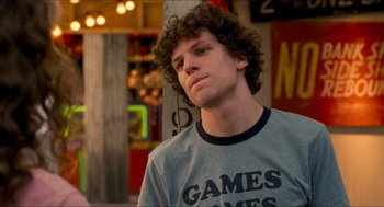 Movie still from “Adventureland” (2009), directed by Greg Mottola – A man with curly hair wearing a t - shirt; Close Up shot, Over the shoulder angle