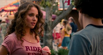 Movie still from “Adventureland” (2009), directed by Greg Mottola – A woman holding a bowl of food in her hands; Close Up shot, Over the shoulder angle