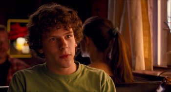 Movie still from “Adventureland” (2009), directed by Greg Mottola – A boy and a girl are looking at the camera; Close Up shot, Over the shoulder angle