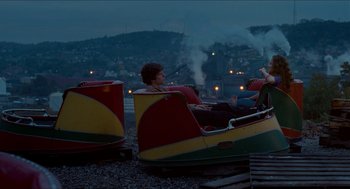 Movie still from “Adventureland” (2009), directed by Greg Mottola – Two people are sitting on a carnival ride; Wide shot, High angle