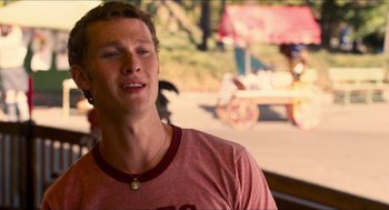 Movie still from “Adventureland” (2009), directed by Greg Mottola – A young man is standing in front of a street; Close Up shot, Over the shoulder angle