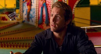 Movie still from “Adventureland” (2009), directed by Greg Mottola – A person sitting in front of a painting; Close Up shot, Over the shoulder angle