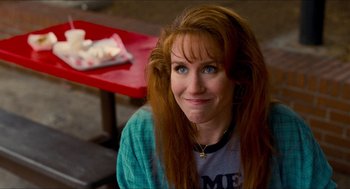 Movie still from “Adventureland” (2009), directed by Greg Mottola – A person sitting in front of a table; Close Up shot, Over the shoulder angle