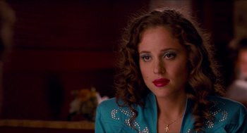 Movie still from “Adventureland” (2009), directed by Greg Mottola – A person with curly hair wearing a blue shirt; Close Up shot, Over the shoulder angle
