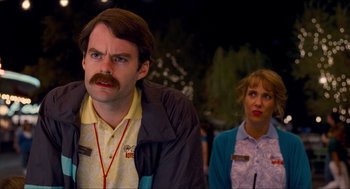 Movie still from “Adventureland” (2009), directed by Greg Mottola – A man and a woman standing next to each other; Close Up shot, Over the shoulder angle