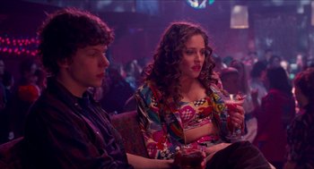 Movie still from “Adventureland” (2009), directed by Greg Mottola – Two people sitting in a room with a drink; Medium shot, Over the shoulder angle