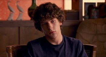 Movie still from “Adventureland” (2009), directed by Greg Mottola – A young man sitting in front of a window; Close Up shot, Over the shoulder angle