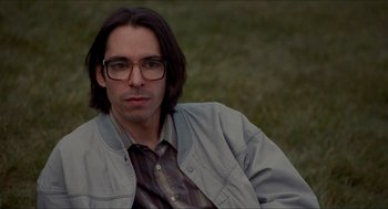 Movie still from “Adventureland” (2009), directed by Greg Mottola – A person wearing glasses and a jacket; Close Up shot, Low angle