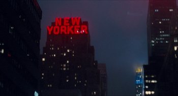 Movie still from “Adventureland” (2009), directed by Greg Mottola – A view of a new yorker sign lit up at night; Extreme Wide shot, Low angle