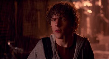 Movie still from “Adventureland” (2009), directed by Greg Mottola – A man with curly hair is looking at the camera; Close Up shot, Over the shoulder angle