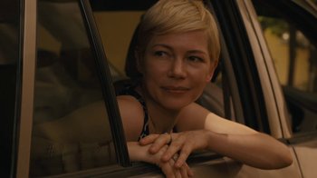 Movie still from “After the Wedding” (2019), directed by Bart Freundlich – A woman leaning out of a car window smiling; Close Up shot, Over the shoulder angle