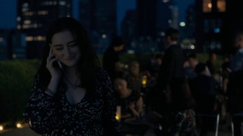 Movie still from “After the Wedding” (2019), directed by Bart Freundlich – A woman talking on a cell phone in front of a crowd of onlookers; Medium shot, High angle