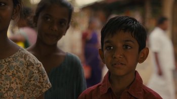 Movie still from “After the Wedding” (2019), directed by Bart Freundlich – A boy and a girl standing next to each other; Close Up shot, Over the shoulder angle