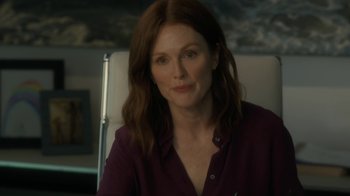 Movie still from “After the Wedding” (2019), directed by Bart Freundlich – Julianne moore in a purple shirt sitting in a chair; Close Up shot, Over the shoulder angle