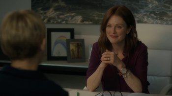 Movie still from “After the Wedding” (2019), directed by Bart Freundlich – Julianne moore sitting at a table with another person; Medium shot, Over the shoulder angle