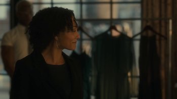 Movie still from “After the Wedding” (2019), directed by Bart Freundlich – A woman standing in front of a row of clothes; Medium shot, Over the shoulder angle