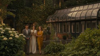Movie still from “After the Wedding” (2019), directed by Bart Freundlich – A group of people standing next to each other in front of a building; Extreme Wide shot, High angle