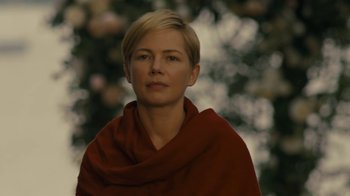 Movie still from “After the Wedding” (2019), directed by Bart Freundlich – A woman with short blonde hair wearing a red scarf; Close Up shot, Over the shoulder angle