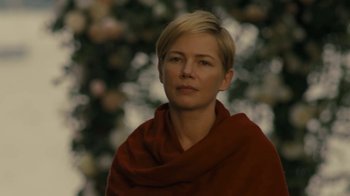 Movie still from “After the Wedding” (2019), directed by Bart Freundlich – A woman with short blonde hair is wearing a red scarf; Close Up shot, Over the shoulder angle