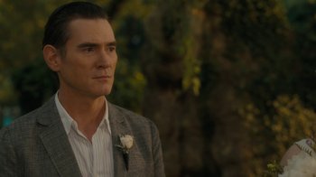 Movie still from “After the Wedding” (2019), directed by Bart Freundlich – A person wearing a suit and tie; Close Up shot, Over the shoulder angle