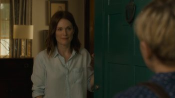 Movie still from “After the Wedding” (2019), directed by Bart Freundlich – A woman standing in front of an open door; Medium shot, Over the shoulder angle