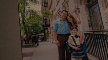 Movie still from “After the Wedding” (2019), directed by Bart Freundlich – A man and a woman and a little girl standing on a sidewalk; Wide shot, Low angle