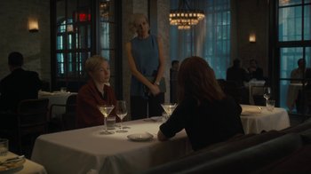 Movie still from “After the Wedding” (2019), directed by Bart Freundlich – Two women are sitting at a table with wine glasses; Medium shot, Over the shoulder angle