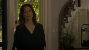 Movie still from “After the Wedding” (2019), directed by Bart Freundlich – A woman standing in front of an open window; Medium shot, Over the shoulder angle