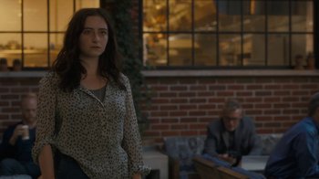 Movie still from “After the Wedding” (2019), directed by Bart Freundlich – A woman standing in front of a brick wall; Medium shot, Over the shoulder angle