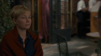Movie still from “After the Wedding” (2019), directed by Bart Freundlich – A woman sitting on a bench in front of a brick wall; Close Up shot, Over the shoulder angle