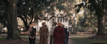 Movie still from “Alice” (2022), directed by Krystin Ver Linden – A group of people standing in front of a building; Extreme Wide shot, High angle