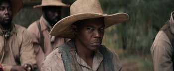 Movie still from “Alice” (2022), directed by Krystin Ver Linden – A person wearing a straw hat; Close Up shot, Over the shoulder angle